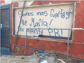 Spanish graffiti on a boarded up post-Maria window frame